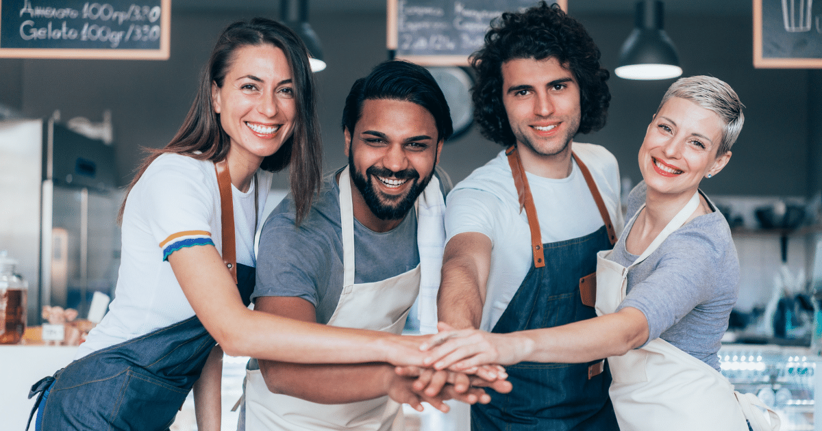 Diverse small business team collaborating and supporting each other to improve business strategies and growth.