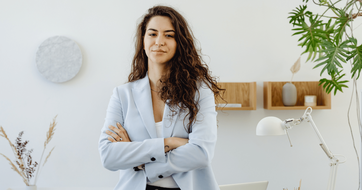 Business professional in a light blazer, promoting Yelp reviews to maximize business revenue and customer engagement.