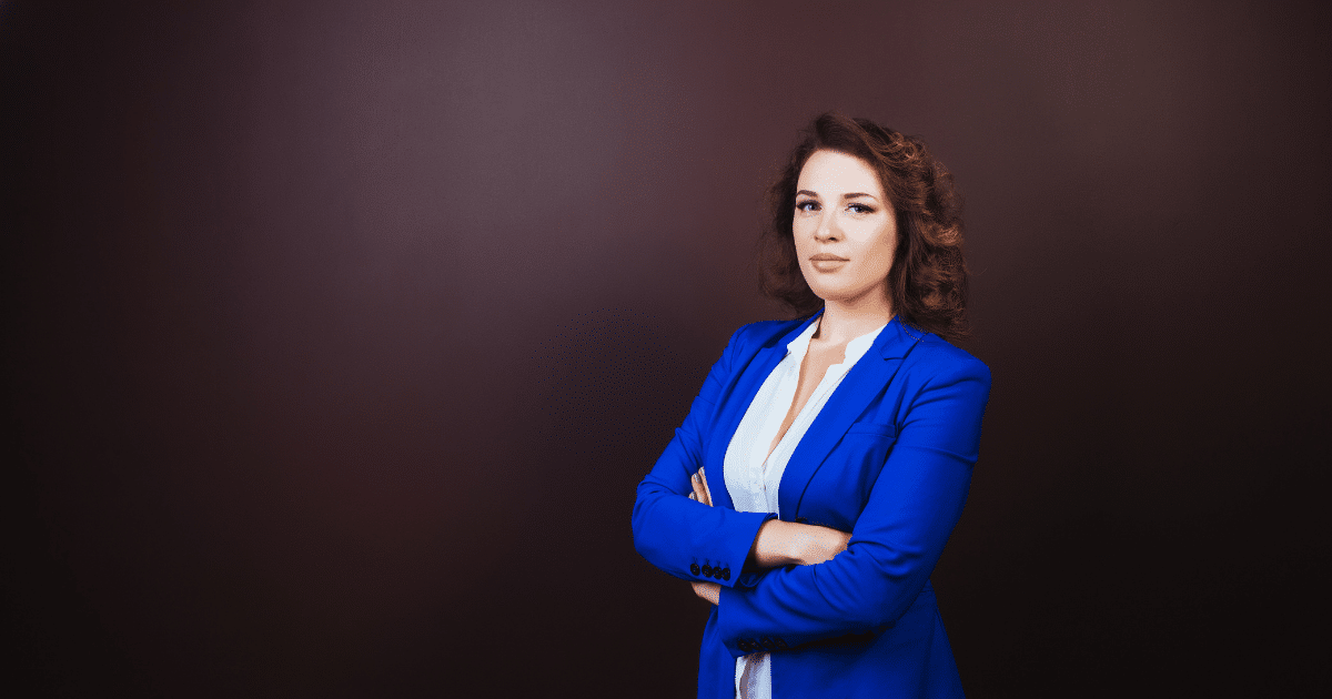 Professional woman in a blue blazer, representing innovative geolocation marketing strategies for sales enhancement.