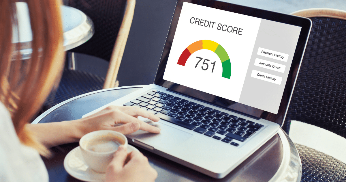 Business credit score monitoring on laptop, showing a score of 751 with key factors like payment history and amounts owed.